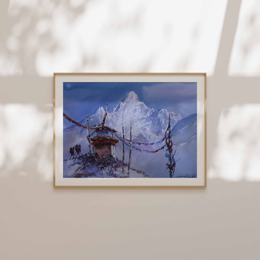 Framed artwork of a snowy landscape with a windmill on a beige wall.