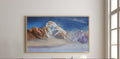 Framed mountain landscape painting above a wooden console table in a bright room.