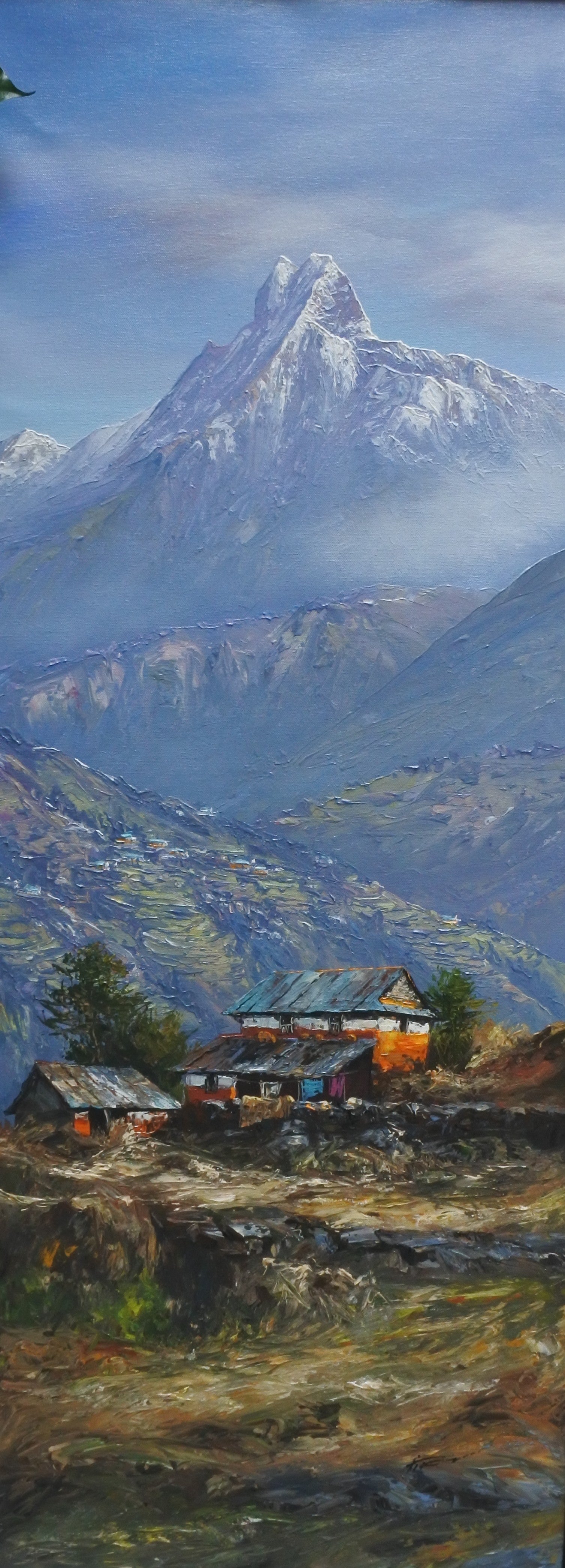 Painting of a mountain landscape with a village at the foot of the mountains.