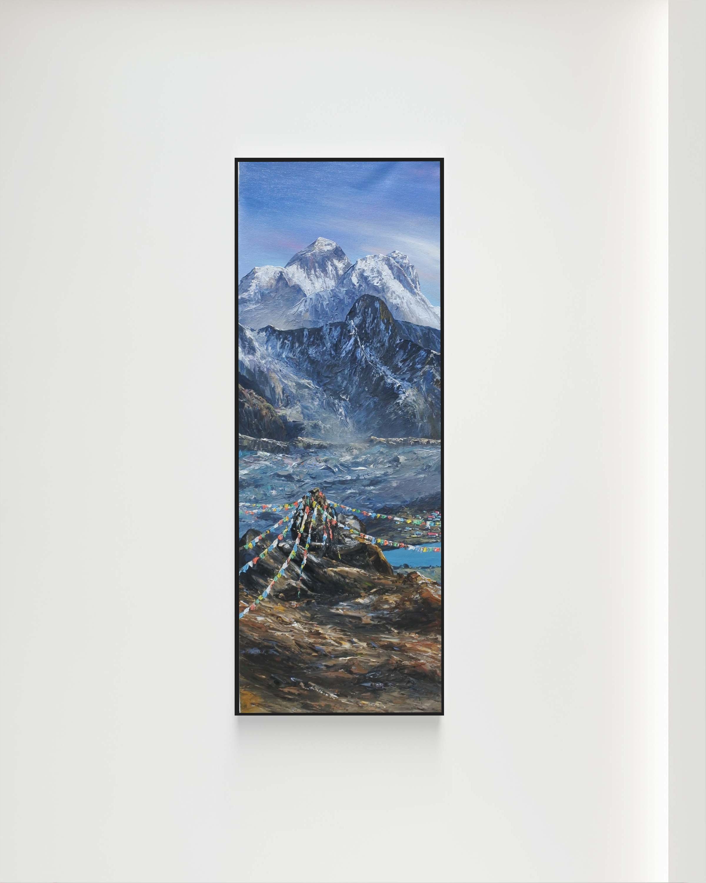Framed picture of a mountain landscape on a white wall