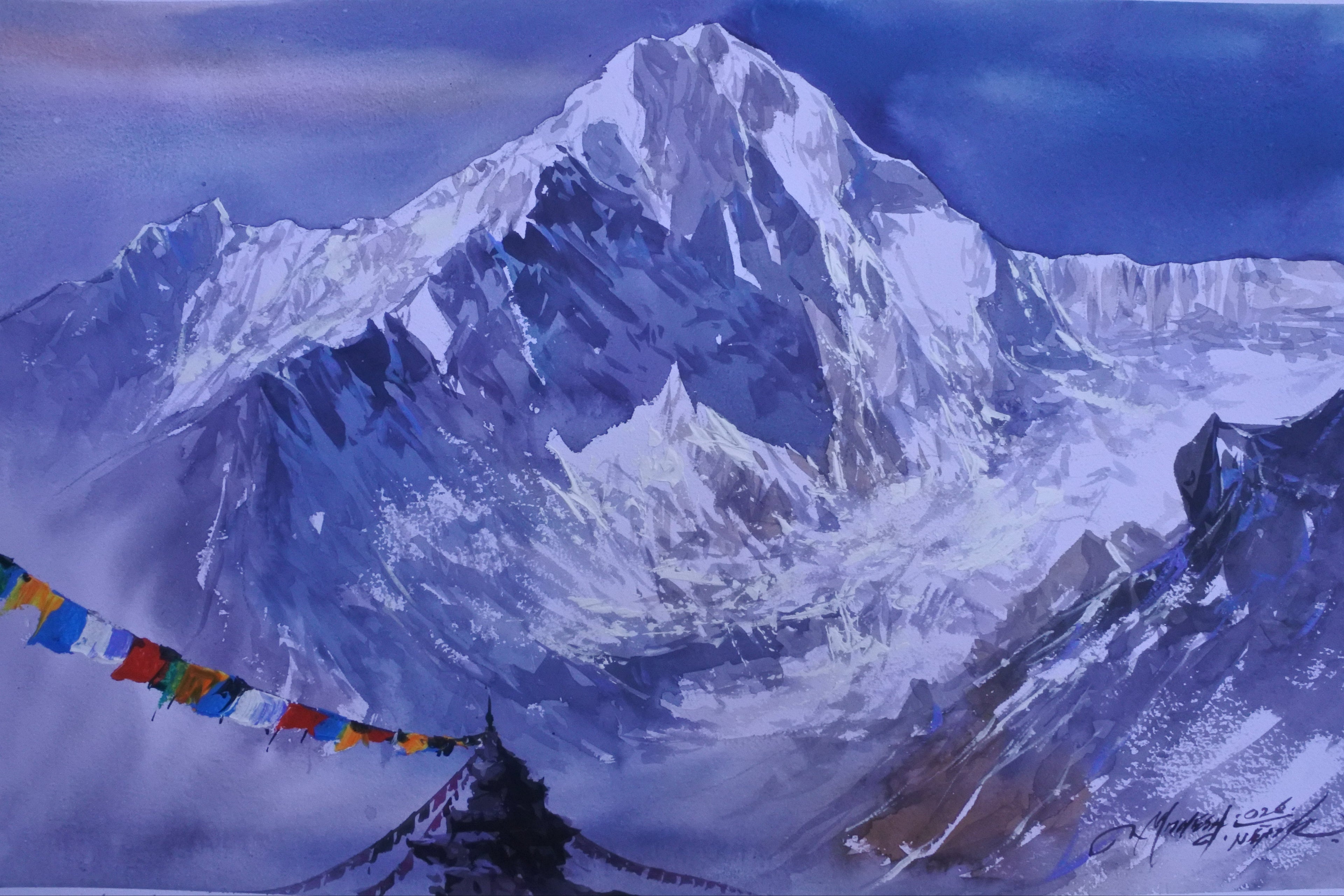 Snowy mountain peak with colorful prayer flags in the foreground