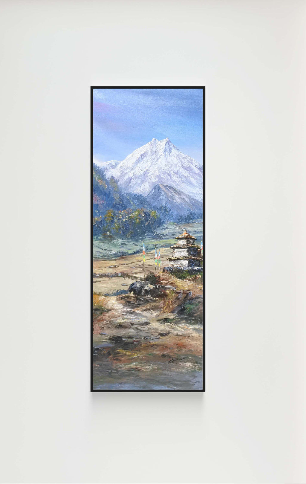 Wall-mounted TV displaying a mountain landscape on a white wall