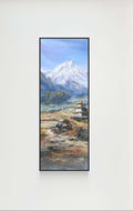 Wall-mounted TV displaying a mountain landscape on a white wall