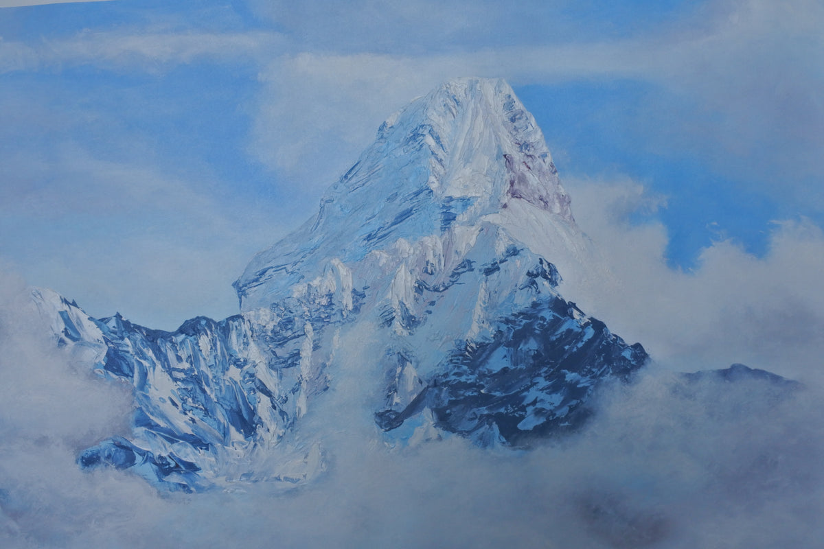 A painted mountain landscape showing a snow-covered peak rising above clouds, with blue sky and white mist surrounding the base.
