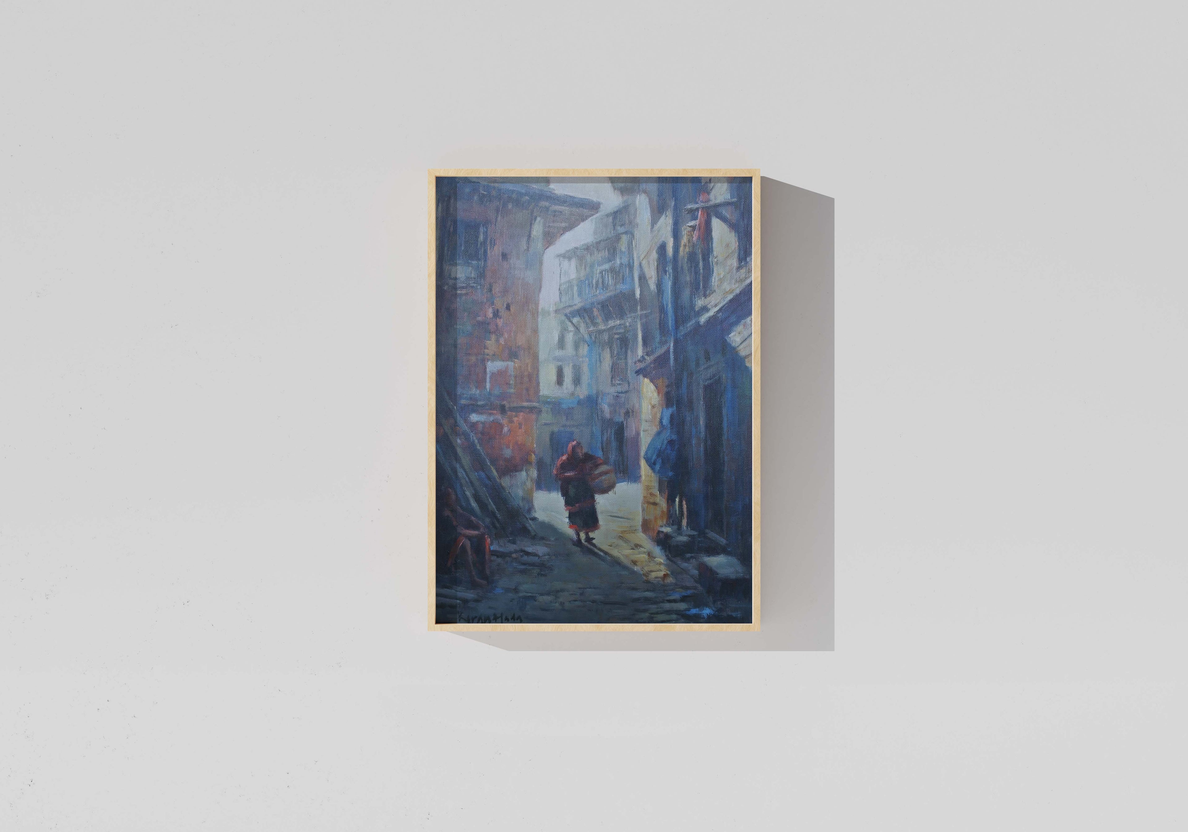 Framed painting of a city street scene on a light gray background. Hand-painted cityscape artwork of a historic alley in Patan, Nepal
