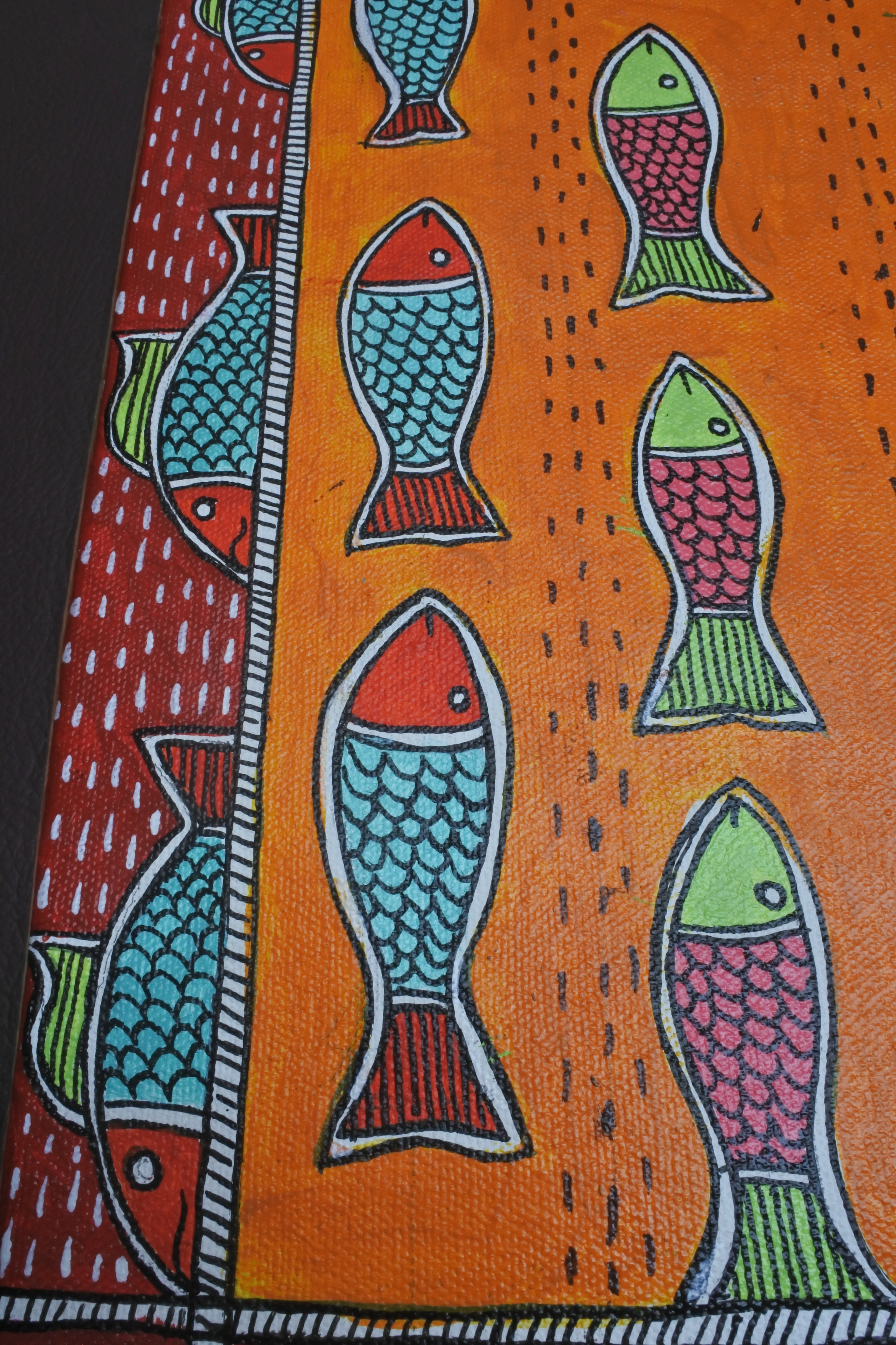 Fabric with colorful fish pattern on an orange background
